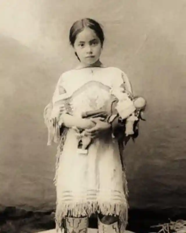 Sioux girl with her doll, 1890.