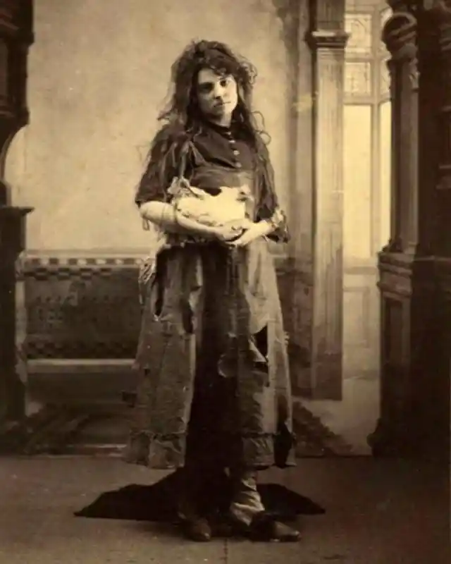 Girl holding her chicken, 1900s.
