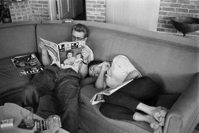 James Dean reading a magazine and Elizabeth Taylor napping during a break on the set of “Giant” in 1955.