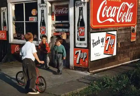 Little kids hanging out at the corner store in 1960.