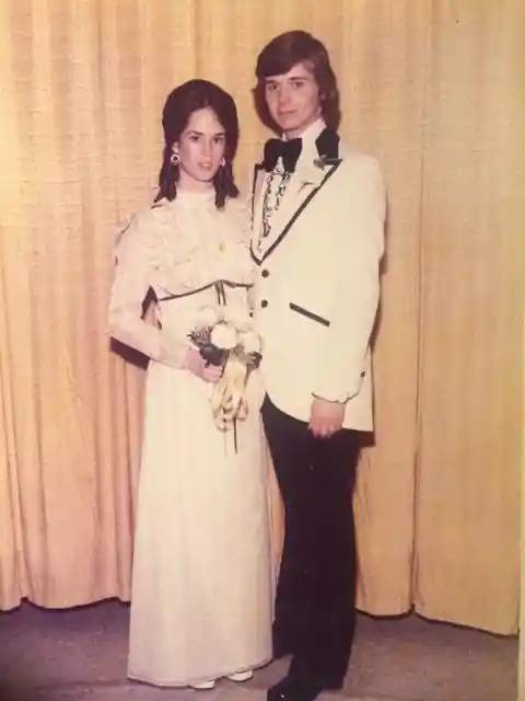 A photo of a groovy couple with plenty of ruffles, going to their prom in 1974.
